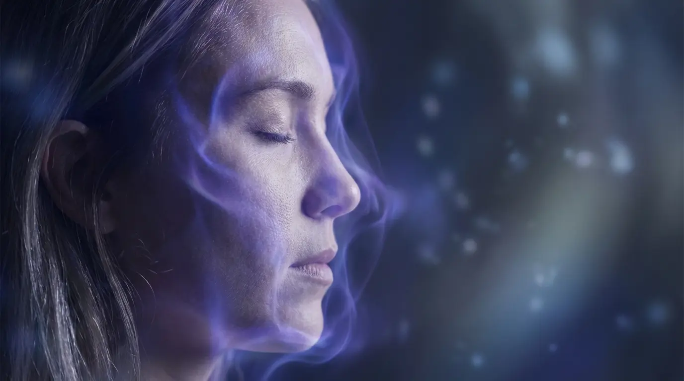 close-up of a person's face in profile with eyes closed, soft blue and violet light surrounding their features suggesting heightened inner perception and intuitive awareness