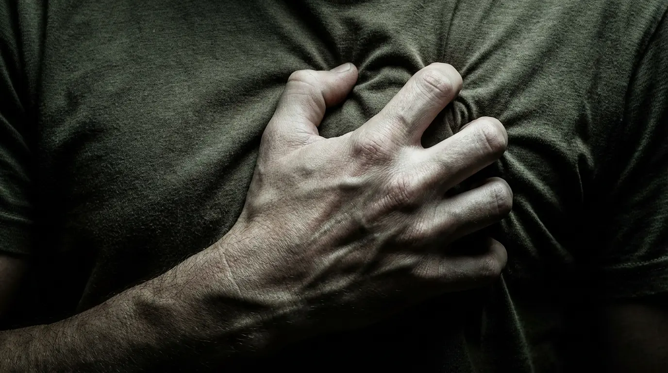 Close up of three fingertips pressing the sternum during a somatic audit for spiritual awakening vs dysregulation.