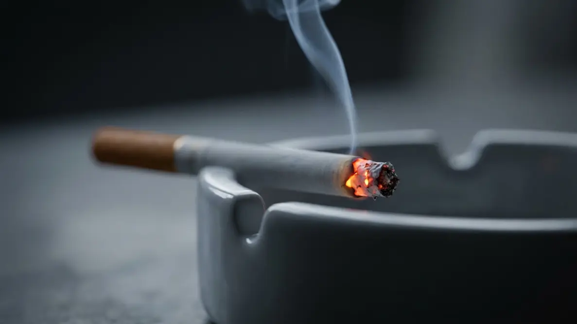 smelling cigarette smoke when no one is smoking, a lit cigarette in an ashtray beside an old coat in an empty room