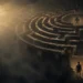 Person walking a labyrinth toward a luminous center in a peaceful setting