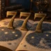 Three brass number sevens standing on an open antique star atlas in warm lamplight