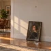 Framed portrait slipping off a living room wall toward the floor