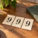 Three paper cards displaying 999 beside a notebook, an editorial illustration of 999 angel number meaning.